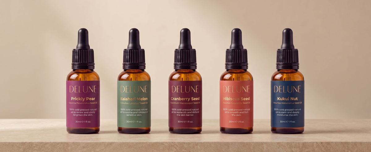 Delune rare seed oils: Prickly Pear, Kalahari Melon, Cranberry, Hibiscus and Kukui, five gold-label bottles in a row